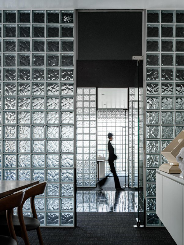 유리벽 넘어로 지나가는 사람 사진